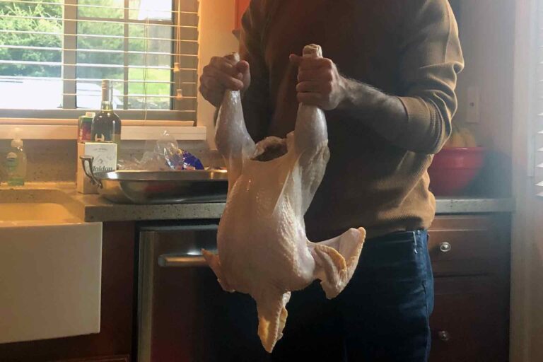 TonyTested.com holding a turkey by the legs